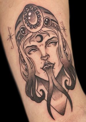 Victor Martin's unique design features a striking blend of traditional and modern elements, with a fierce snake intertwining with a mysterious lady head on the forearm.