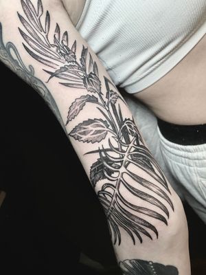 Captivating black and gray floral sleeve tattoo featuring intricate leaf motif, expertly done by Victor Martin.