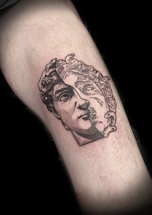 Get an impressive black and gray statue tattoo on your upper leg by Victor Martin for a timeless and detailed design.