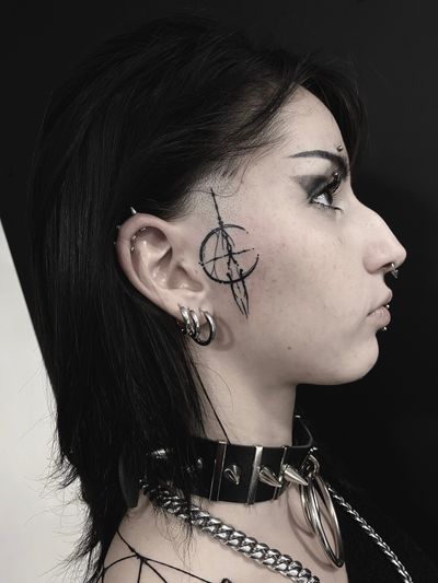 Explore the intricate blackwork design by Victor Martin, featuring a stunning geometric circle pattern on the side of the face.