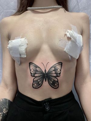 Get a stunning black and gray dotwork butterfly tattoo on your stomach by skilled artist Victor Martin.