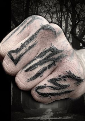 Unique lettering pattern tattoo by Victor Martin on the finger, showcasing skillful detail and creativity.