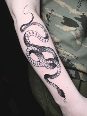 Traditional black and gray snake tattoo on forearm by renowned artist Victor Martin.