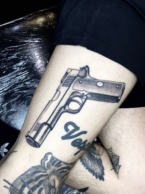Get inked with this stunning black and gray pistol tattoo on your upper leg by renowned artist Victor Martin. Perfect for fans of realism style tattoos.