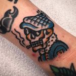 Get inked with a classic skull and skeleton design by Alessandro Lanzafame on your arm. Traditional style with a bold statement.