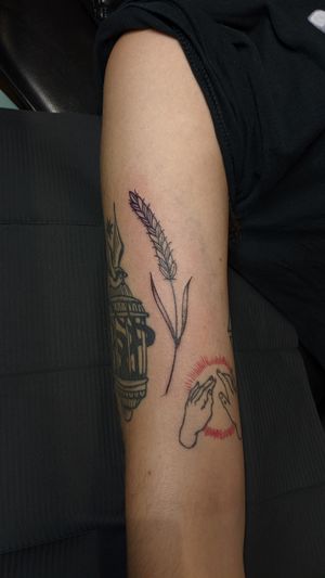 Elegant floral design combining flowers and wheat on the upper arm by Luca Salzano.