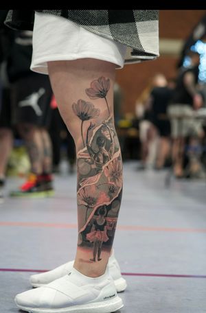 Experience the elegance of ballet with this stunning black and gray floral tattoo on your lower leg. Soheyl Astangi's illustrative realism brings a beautiful woman dancer to life.