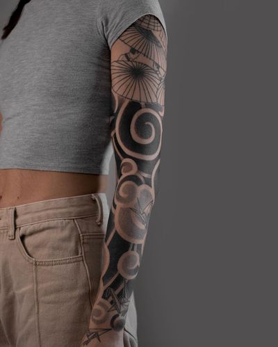 Experience the intricate beauty of blackwork Japanese design with this stunning umbrella pattern sleeve tattoo by FKM TATTOO.
