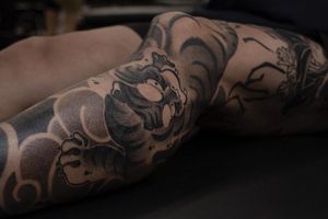 Experience the power and beauty of a traditional Japanese tiger tattoo on your lower leg by the talented artist FKM TATTOO.