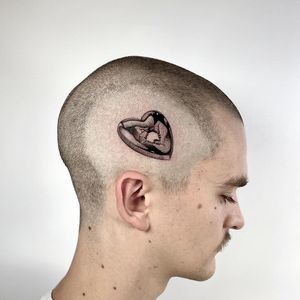 Experience Martin Rosenberg's skillful black and gray dotwork technique in this intricate heart tattoo on the side of your face.