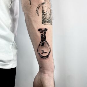 Experience the artistry of Martin Rosenberg with this intricately detailed perfume bottle tattoo on your lower arm. Perfect for those who appreciate micro realism!