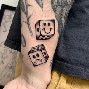 Get lucky with this classic traditional tattoo of dices on your lower arm done by Laurel.