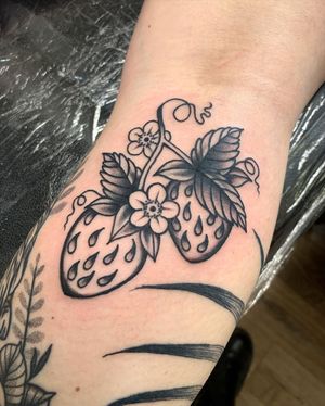 Get a juicy and vibrant traditional strawberry tattoo by the skilled artist Laurel, perfect for your arm!