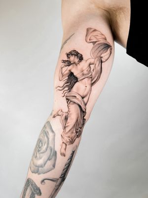 Stunning black and gray upper arm tattoo of a woman by Delphin Musquet. Elegantly captures the beauty and grace of femininity.