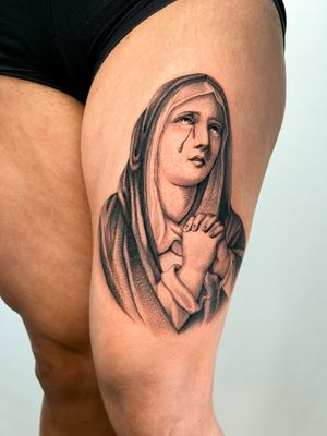 Capture the grace of Mary with this black and gray tattoo by Delphin Musquet. Perfect for those seeking a stunning piece of art.