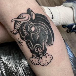 Capture the strength and power of a bull with this traditional style tattoo by Laurel on your lower leg.