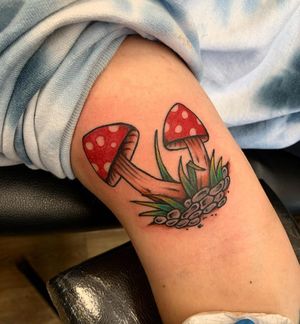Unique traditional style tattoo of mushrooms by Laurel, perfect for arm placement.