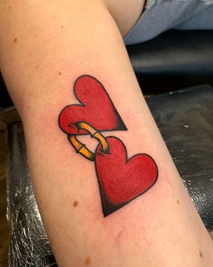 Get a classic traditional heart tattoo on your upper arm by the talented artist Laurel for a timeless look.