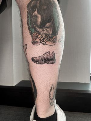 Get a sleek and minimalistic Nike shoe tattoo on your lower leg by the talented artist Martin Rosenberg. Show off your love for sneakers in a unique and artistic way.