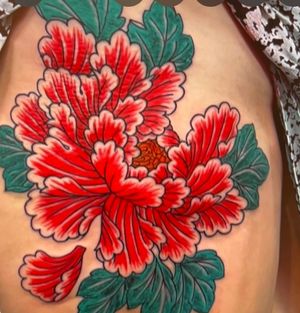 Experience the beauty of traditional Japanese art with this stunning peony tattoo by the renowned artist Ami James. Perfect for the upper leg, this design is sure to make a bold statement.