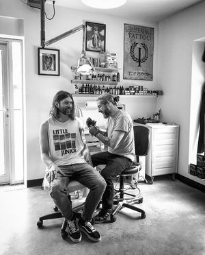 Ronan tattooing July Talk's drummer Danny Miles