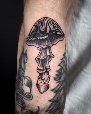 Explore the whimsical world of mushrooms with this intricate illustrative tattoo by the talented artist Kat Jennings.