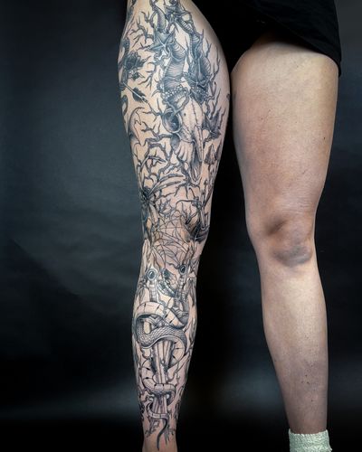 Get a unique tattoo by Kat Jennings featuring a snake, insect, spider, skull, dagger, thorns, and patchwork design.