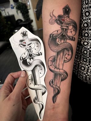 Get a unique illustrative tattoo of a snake and dagger by the talented artist Kat Jennings. Perfect blend of danger and beauty!