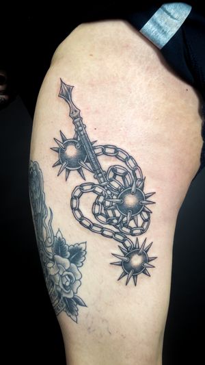 Get inked with this striking dotwork design by Kat Jennings, featuring intricate details of a morning star and flail.
