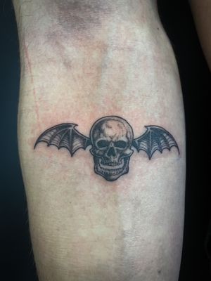 Get a bold and unique look with this illustrative tattoo featuring a bat and skull design by the talented artist Kat Jennings.