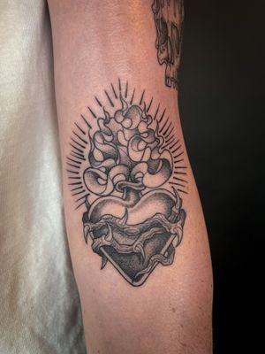 Experience divine beauty with this illustrative dotwork tattoo of a sacred heart, beautifully crafted by the talented artist Kat Jennings.
