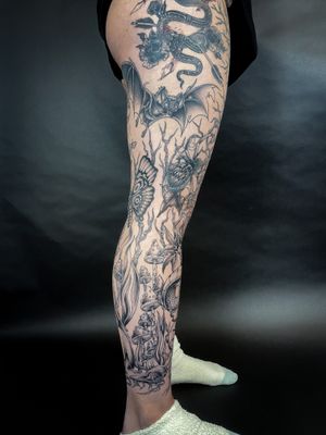 Embrace the darkness with a stunning tattoo by Kat Jennings featuring a bat, snake, moth, spider, mushroom, and thorns.