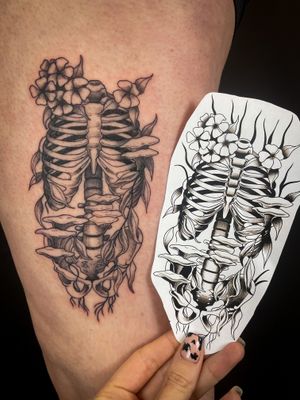 Kat Jennings beautifully blends dotwork technique with intricate illustration to create a stunning floral skeleton ribcage design.