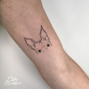 Get a fine line tattoo of your beloved pet by talented artist Chloe Mickham. This minimalistic design captures the essence of your furry friend in a simple yet beautiful way.