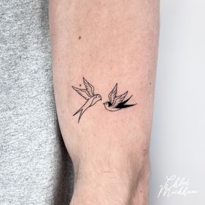 Get a beautiful and delicate fine line swallow tattoo done by the talented artist Chloe Mickham. Perfect for lovers of minimalist ink.