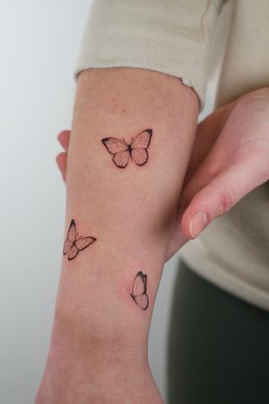 This illustrative tattoo by Viola features a delicate butterfly motif, perfect for those looking for a feminine and elegant design.