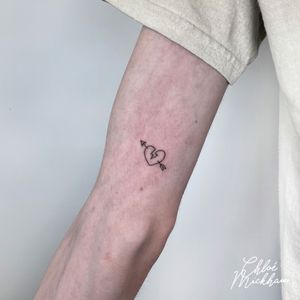 Sleek and delicate heart design by Chloe Mickham, perfect for a subtle yet impactful tattoo.