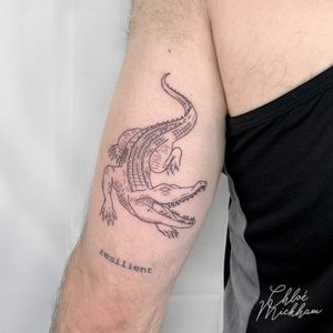 Get a unique and detailed crocodile tattoo done in fine line style by the talented artist Chloe Mickham.