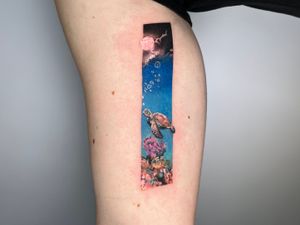 Dive into the depths with this micro_realism tattoo featuring a sea turtle, fish, coral reef, and frame illustration.