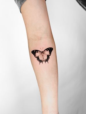 Experience the unparalleled beauty of a tiny, lifelike butterfly tattoo expertly created by Viola. Perfect for those seeking intricate details in body art.