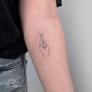 Beautiful fine line tattoo of a hand symbolizing hope, expertly done by Chloe Mickham.