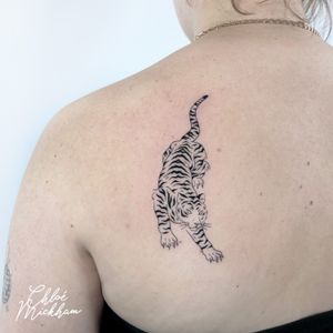 Elegant tiger design by Chloe Mickham, combining fine line work and illustrative details for a striking tattoo.