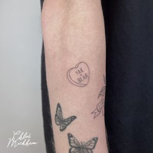 Adorn your skin with Chloe Mickham's fine line tattoo featuring a minimal heart design with a sweet candy twist.
