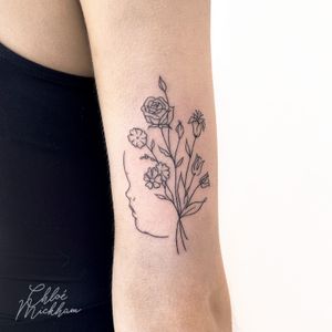 Fine line tattoo featuring a beautiful bouquet of flowers and baby elements, expertly done by Chloe Mickham.