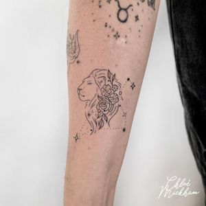 Get a stunning illustrative lion tattoo with intricate fine line details by Chloe Mickham, a talented tattoo artist.
