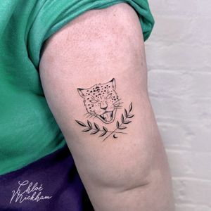 Get a fierce and elegant touch with this illustrative fine line leopard tattoo by Chloe Mickham. Perfect for wildlife lovers!