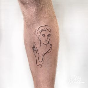 Beautiful fine line tattoo by Chloe Mickham featuring a detailed statue, face, and hand motif.