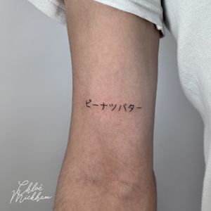 Get a beautiful fine line tattoo featuring small kanji lettering by the talented artist Chloe Mickham, perfect for a subtle and stylish look.