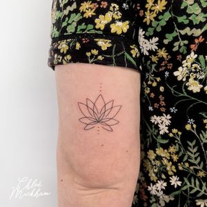 Experience the delicate beauty of a fine line lotus tattoo by Chloe Mickham. Simple yet elegant, this design is perfect for those seeking a minimalistic touch.