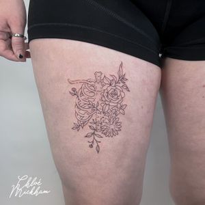 Elegant fine line tattoo featuring a beautiful flower design on the ribcage, expertly done by Chloe Mickham.